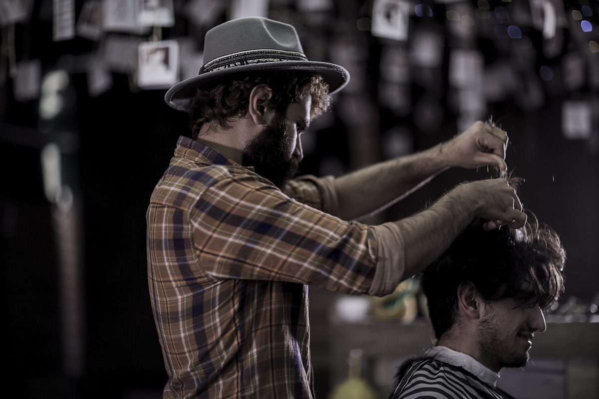 A stylist cutting and styling hair